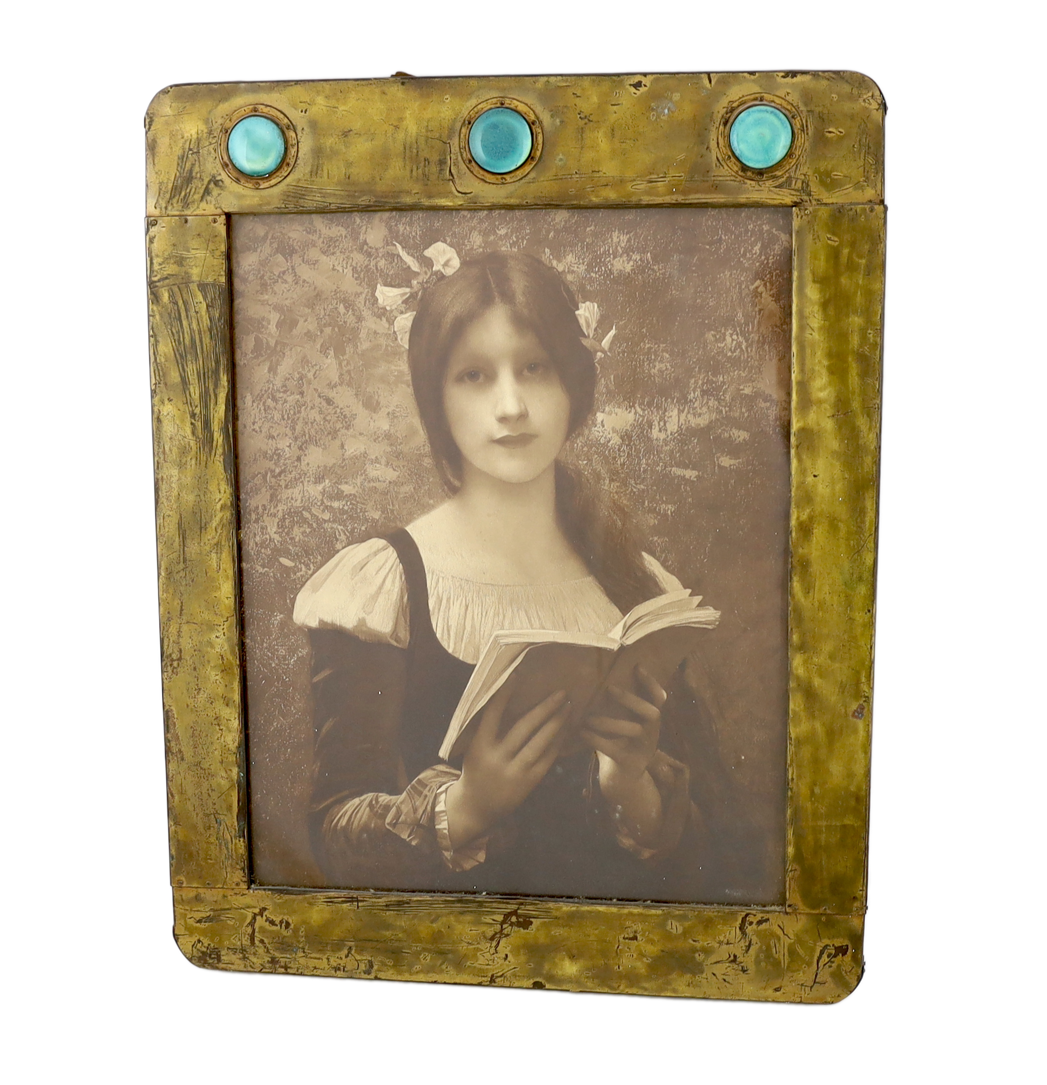 An Arts & Crafts brass picture frame, 45cm wide, 57cm high